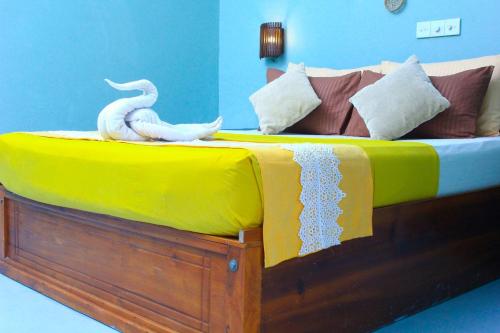 a bed with two white swans on it at 7elements - Boutique Hotel & Restaurant in Weligama