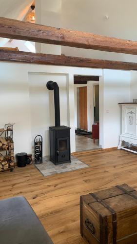 a living room with a wood stove in a room at Damwildfarm in Rollerbü Südschweden in Tyringe