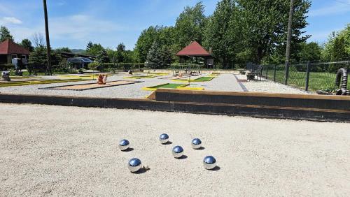 a group of blue balls on the ground in a park at SEDRA Holiday Resort-Adults Only-Bed & Breakfast in Grabovac