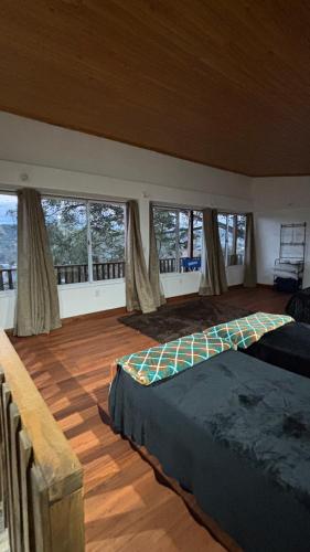 a bedroom with a bed in a room with windows at La Casa de Bianca in El Soberbio