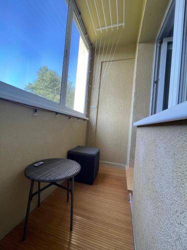 a small room with a stool and a window at Dani apartment in Panevėžys