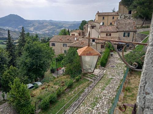 a view of a village with a street light at Giardino in piazza, casa in pietra a San Leo in San Leo