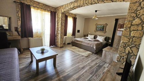 a bedroom with a bed and a table in a room at SEDRA Holiday Resort-Adults Only-Bed & Breakfast in Grabovac