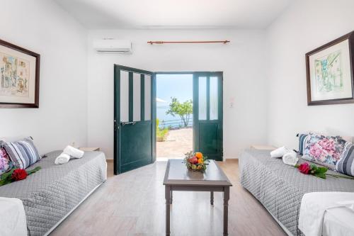 a living room with two couches and a table at Averto in Benitses