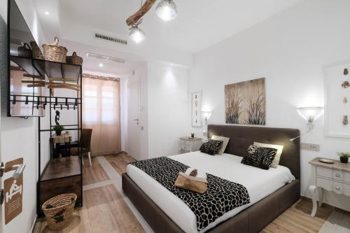 a bedroom with a bed with a black and white blanket at RADICI DI LUNA Exclusive Design in Castelsardo