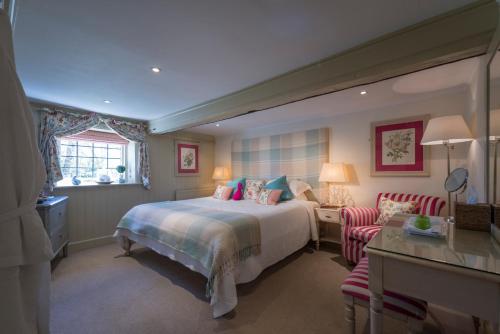 a hotel room with a bed and a table and chairs at The Old Mill in Lymington