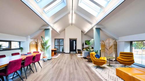 an open living room with skylights and tables and chairs at For Students Only Accommodation in the Heart of York in York