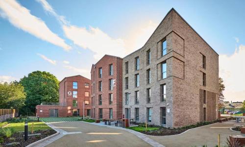 a rendering of a brick building with a church at For Students Only Accommodation in the Heart of York in York