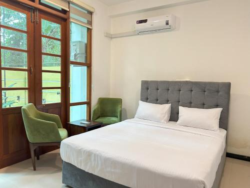 Ένα ή περισσότερα κρεβάτια σε δωμάτιο στο Trident Kandy Homestay