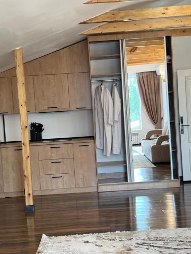 a room with a closet with a mirror at FlowerHouse in Karakol