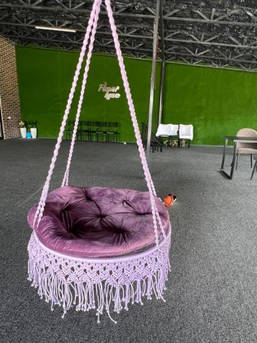 a purple swing with a bird sitting on it at FlowerHouse in Karakol