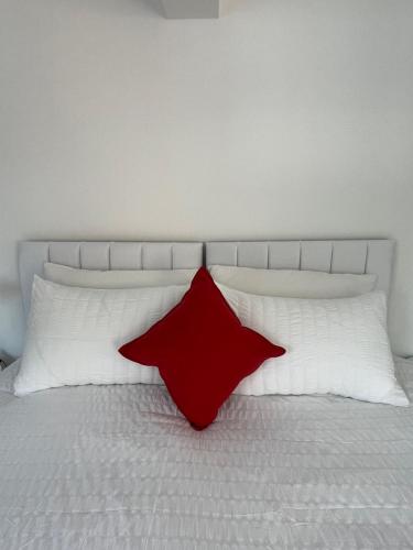a red star on a bed with two white pillows at Yugogo One-Bedroom Apartment 37 London Road in St. Albans