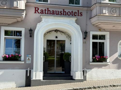 a facade of a building with an archway and a door at Rathaushotels All Inklusive in Kurort Oberwiesenthal