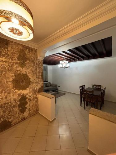 a living room with a table and a dining room at Chic Studio in Agdal Walk to Everything in Rabat