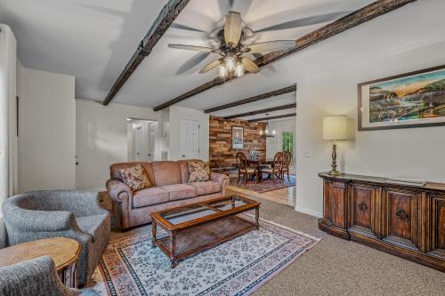 a living room with a couch and a table at Otter Manor - Wifi - Fire Pit - Gameroom- Grill - Private Trail in Berkeley Springs