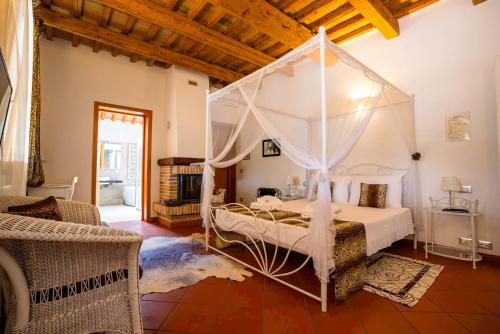 a bedroom with a bed with a canopy at Resort Tenuta La Rotta - Rooms & Pool in Ravenna