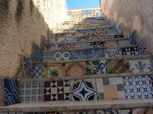 a set of stairs covered in different types of tiles at Favignana Vacanze in Favignana