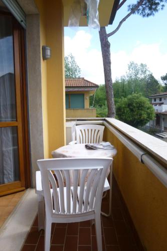 a white table and chairs sitting on a balcony at Casa Primavera in Cinquale