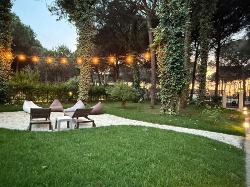 a garden with two chairs and a table and lights at Villa Zen Oasis in Golem