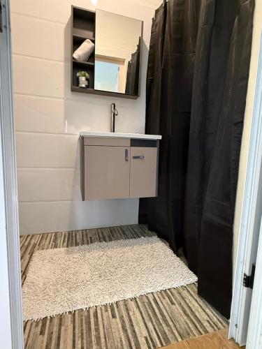 a bathroom with a sink and a shower at Grand Baie la Croisette villa du bonheur Chez Marie in Hermitage