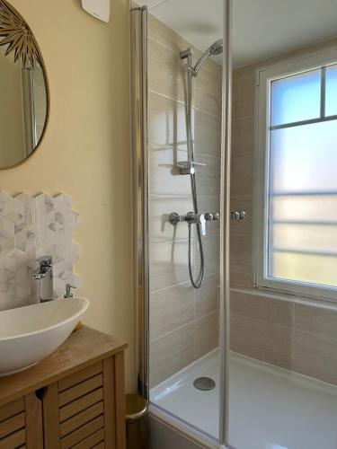 une salle de bain avec douche et lavabo dans l'établissement Chaleureuse Maison Familiale Etretat Plage, à Étretat
