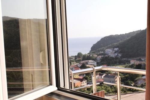 a view of the ocean from a window at Mahakala Center in Petrovac na Moru