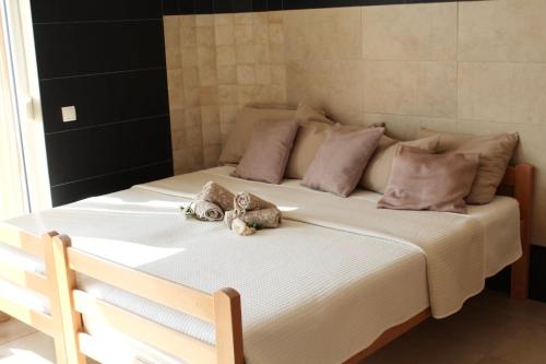 a bed with two stuffed animals sitting on it at Mahakala Center in Petrovac na Moru