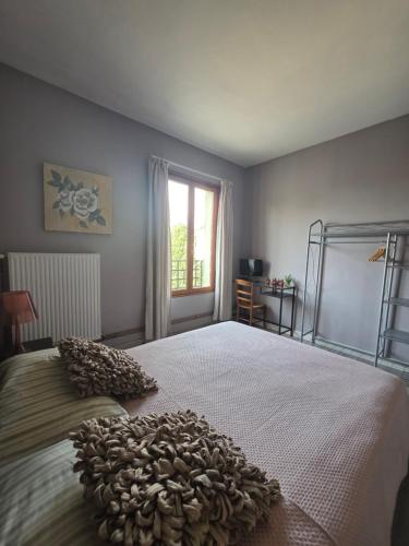 a bedroom with a large bed with a large bedspread at Chez Kahina ancien hôtel Robert in Giat