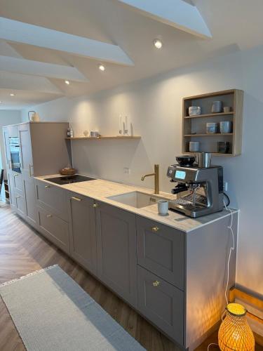 a kitchen with a sink and a counter top at Cozy harbor house in Nibe in Nibe