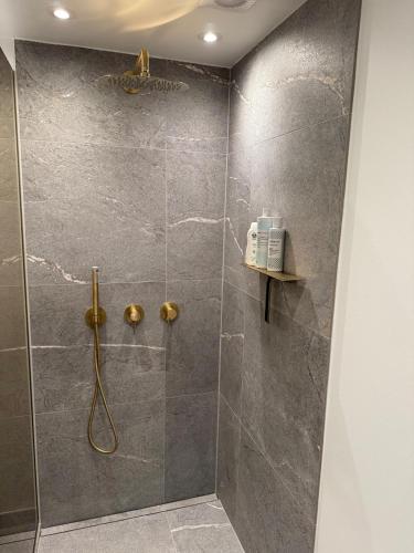 a bathroom with a shower with a glass door at Cozy harbor house in Nibe in Nibe