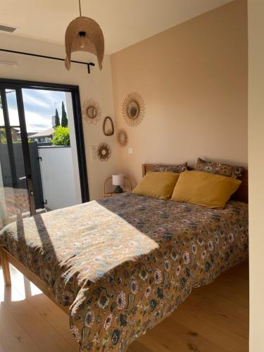 a bedroom with a bed and a large window at Charmante chambre chez l habitant in La Teste-de-Buch