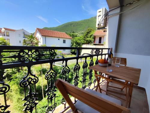 a balcony with a wooden bench and a view at Apartments Skipper bay Baosici in Baošići