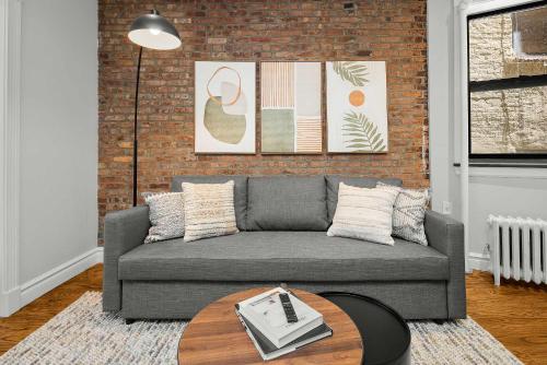 a living room with a couch and a table at Chic NYC Escape in Vibrant Downtown in New York