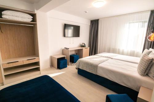 Postel nebo postele na pokoji v ubytování Hotel-Apartments Roxy&Maryo