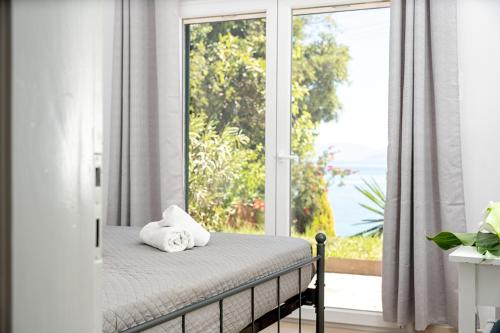 a bedroom with a bed in front of a window at Averto in Benitses