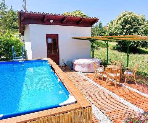 a house with a swimming pool and a table and chairs at Villa Caroiba in Karojba