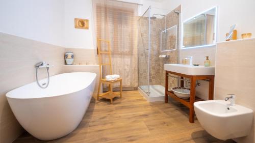 a bathroom with a tub and a sink and a shower at La casa di Marko in Rabac