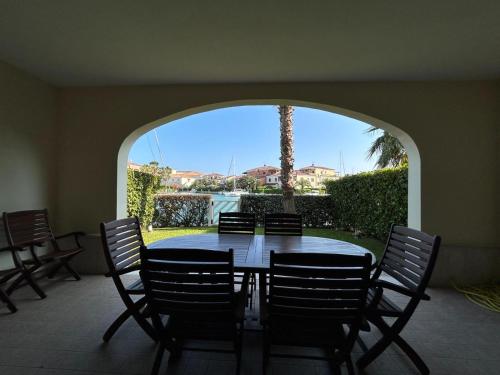 a table and chairs in a room with a large window at Casa Dodò - Una stella a Marinagri in Policoro