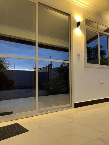 a large glass window of a building with a view at Spacious Room in Paje in Paje