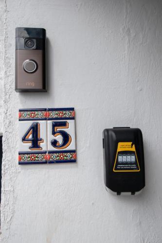 a clock and a box on a wall at Penthouse at the White House near Edinburgh in Bathgate