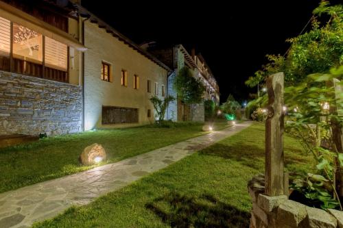 a garden at night with lights on the grass at Archontiko Liamas in Stavros