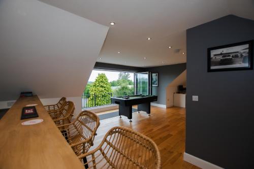a living room with a table and a pool table at Penthouse at the White House near Edinburgh in Bathgate