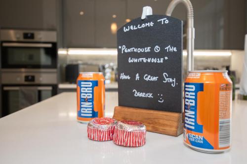 a counter with a chalkboard and two cans of food at Penthouse at the White House near Edinburgh in Bathgate