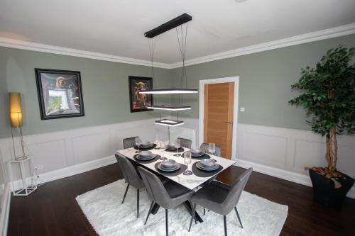 a dining room with a table and chairs at Penthouse at the White House near Edinburgh in Bathgate