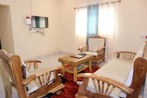 a living room with a wooden table and chairs at Keshav Villa Sea View Holiday Home in Jāmb