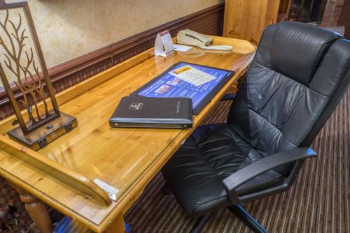 a desk with a chair and a laptop on it at Best Western Fireside Inn in Kingston