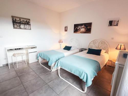 - 2 lits dans une pièce avec piano dans l'établissement Charmant studio dans une ecurie en Touraine, à Saint-Roch