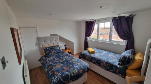 a bedroom with a bed and a window at Spencer , 4 bed slp 8 semi in Lee On The Solent in Lee-on-the-Solent