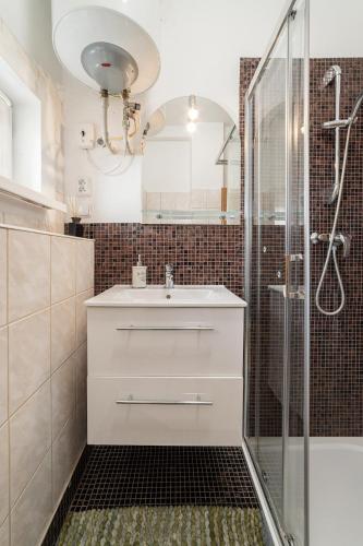 a bathroom with a sink and a shower at No8 Spacious City Center Apartment in Bratislava