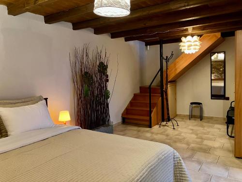 a bedroom with a bed and a staircase in a room at Melivista in Melívoia